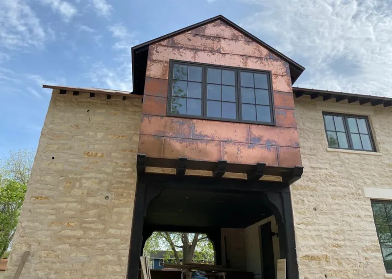 Copper metal panel facade on a stone building for Roof Repair in Los Banos